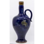 A Royal Doulton Art Nouveau whisky flagon, blue glaze with thistles, approx 27cm high, impressed