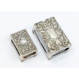 A silver match box, Chester 1911, along with another larger version,  both embossed with scrolled