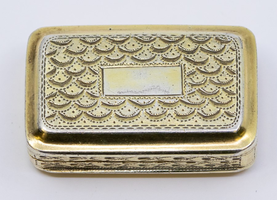 A George III silver-gilt viniagrette, the front and reverse with scalework, central vacant
