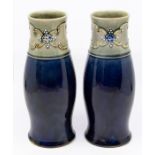 A pair of Royal Doulton stoneware vases, deep green banding applied with tube-lined and bead