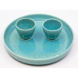 A pair of Ruskin crystalline glazed egg cups and a circular foot stand, turquoise glaze, cups approx