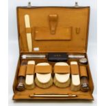 A George V leather Gentleman's travelling case, fitted interior to include four ivory mounted