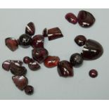 A collection of loose garnet stones mainly cabochon and beads, some a/f broken total weight approx