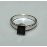 A single stone green tourmaline ring, size Q, the cushion cut stone on an 18ct white gold shank.