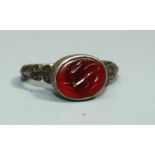 A Greek style silver and carnelian Ring with oval bezel set carnelian intaglio of leaping dog, set