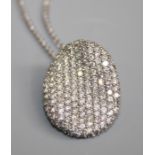 A 14K white gold oval diamond Pendant, pavé set over 140 round brilliant-cut diamonds, estimated
