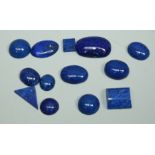 A collection of cabochon lapis lazuli stones, varying sizes and shapes, total gross weight approx