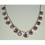 An early 20th Century amethyst set 9ct rose gold necklace, comprising hexagonal shaped amethyst