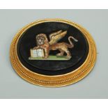 An Etruscan style micro mosaic brooch, the oval form inlaid with a mosaic depiction of a lion within