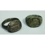 A Roman  style bronze Ring with oval plate bezel having crescent and striped markings together