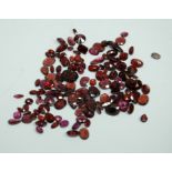 A collection of loose garnet stones, with a mix of different cuts