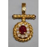 An unmarked 18ct gold ruby and diamond cluster pendant of Coptic cross form, centrally set with a