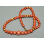 A coral bead necklace, comprising graduated round beads, the largest approx 12mm the smallest approx