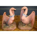 A pair of large 20th century terracotta chained swans of Buckingham. Each on canted square plinth.