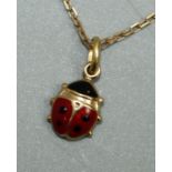 An enamel and 18ct gold pendant in the form of a lady bird, size approx 6mm, stamped 750,  on a fine