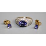A Rock & Co. tanzanite dress Ring, claw set central oval-cut tanzanite, approx. 8.5mm x 7mm on a