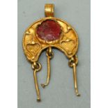 A Roman style gold Pendant, of crescent form with applied granulated border and double heart motifs,