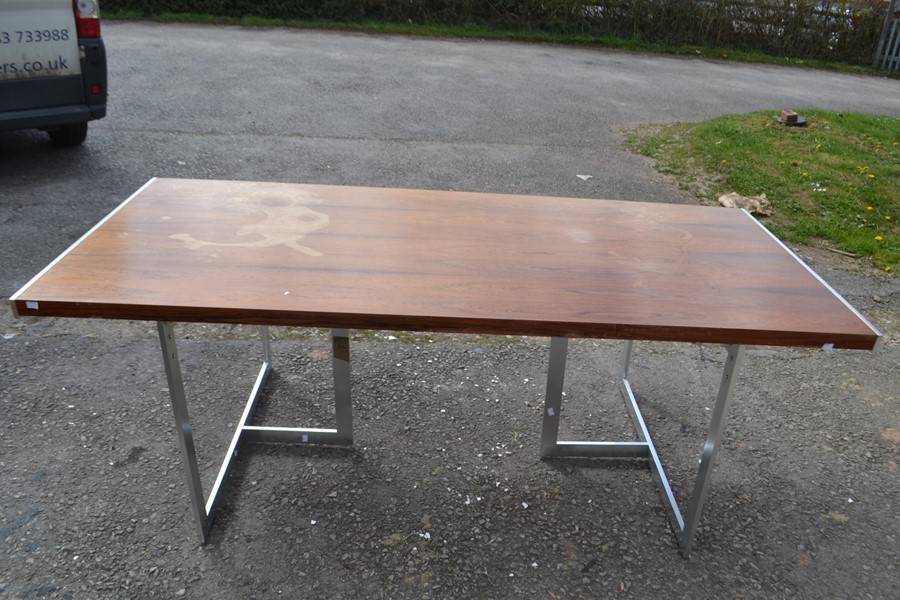 A Scandinavian rosewood refectory table raised on a pair of chrome tripod supports. 71cm H x 199cm W