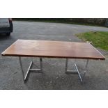 A Scandinavian rosewood refectory table raised on a pair of chrome tripod supports. 71cm H x 199cm W