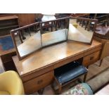 A 1970s teak dressing table, mirrored back, fitted with three frieze drawers and two doors