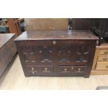 An early 18th Century oak joined mule chest, panelled front, two drawers to base, with geometrically