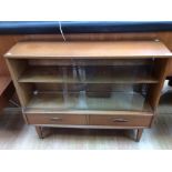 A mid 20th Century teak glazed bookcase, fitted with two glass sliding doors, two drawers to base