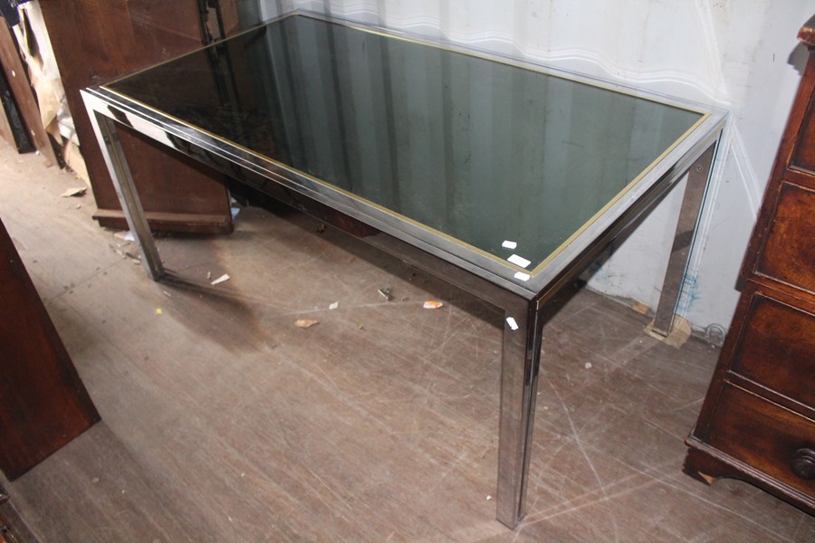 A contemporary Italian chrome framed and glass inset dining table, square supports