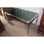 A contemporary Italian chrome framed and glass inset dining table, square supports