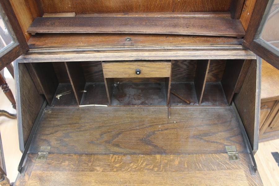 An early 20th Century oak bureau bookcase, fitted with two doors enclosing wooden shelves, the - Image 5 of 6