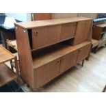 A Portwood teak 1970s side unit, two sliding doors to top, fold down cupboard, with two doors and