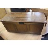 A late 17th / early 18th Century joined oak chest, circa 1700, having a plank lid, three panels to