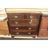An early 20th Century chest of drawers, having two short over three long graduated drawers, brass