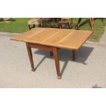 An early 20th Century oak draw-leaf dining table, with leaves folding over, square legs, 75cm