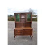 An Art Nouveau oak sideboard, circa 1910, with glazed upper section fitted with stained glass doors,