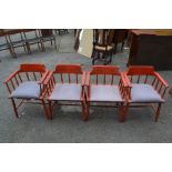 A set of four mid 20th Century red stained armchairs, each with rodded backs and arm supports,