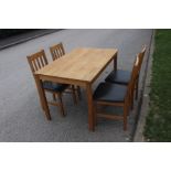 A contemporary oak dining table and a set of four oak side chairs, of slatted form; the table