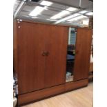 Two matching 1970s teak veneered wardrobes, comprising single mirrored wardrobe and a further double