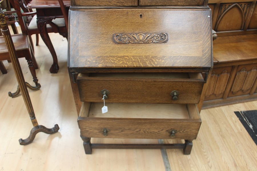 An early 20th Century oak bureau bookcase, fitted with two doors enclosing wooden shelves, the - Image 6 of 6