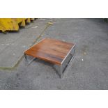 A 1970's rosewood coffee table in a Scandinavian manner, in a rectangular shape, raised on chrome