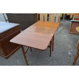 A teak drop leaf dining table and a set of four chairs; the table measuring 72cm high, 75cm wide,