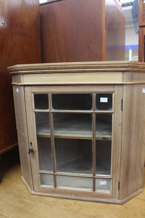 An early 20th Century beech and pine glazed hanging corner cupboard, 57cm high, 63cm wide