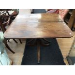 A Regency mahogany twin pedestal dining table, circa 1825, with one additional leaf, reeded sabre