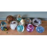 A collection of glass paper weights (q)