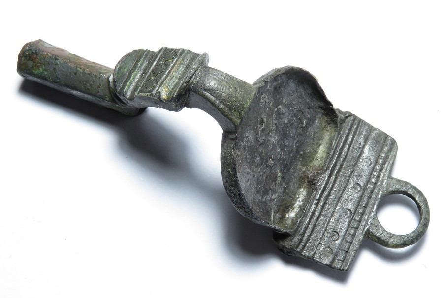 Roman bronze brooch. A large silvered bronze bow brooch of unusual form. The head is flat with