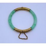 A Qing dynasty 18ct gold mounted Jade bangle