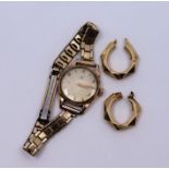 A lady's Omega gold case wristwatch on replacement gilt metal strap together with pair of 9ct hoop