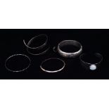 A 9ct gold bangle and a collection of silver bangles