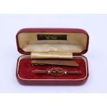 A 9ct Gold tie clip, gold brooch, silver Scottish brooch, bangle and seed pearl necklaces