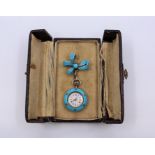 An Edwardian turquoise enamel French fish watch, an enameled bow pin, the based studded with pearls,