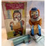 Tinplate: A vintage battery operated, remote control, Happy 'n' Sad Magic Face Clown, Made in